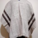 White pure wool poncho with 4 vertical dark colored stripes.