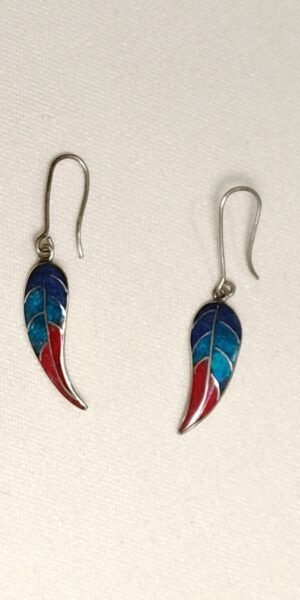 Silver dangle earrings with a gangling leaf with red, turquoise and blue inlay.