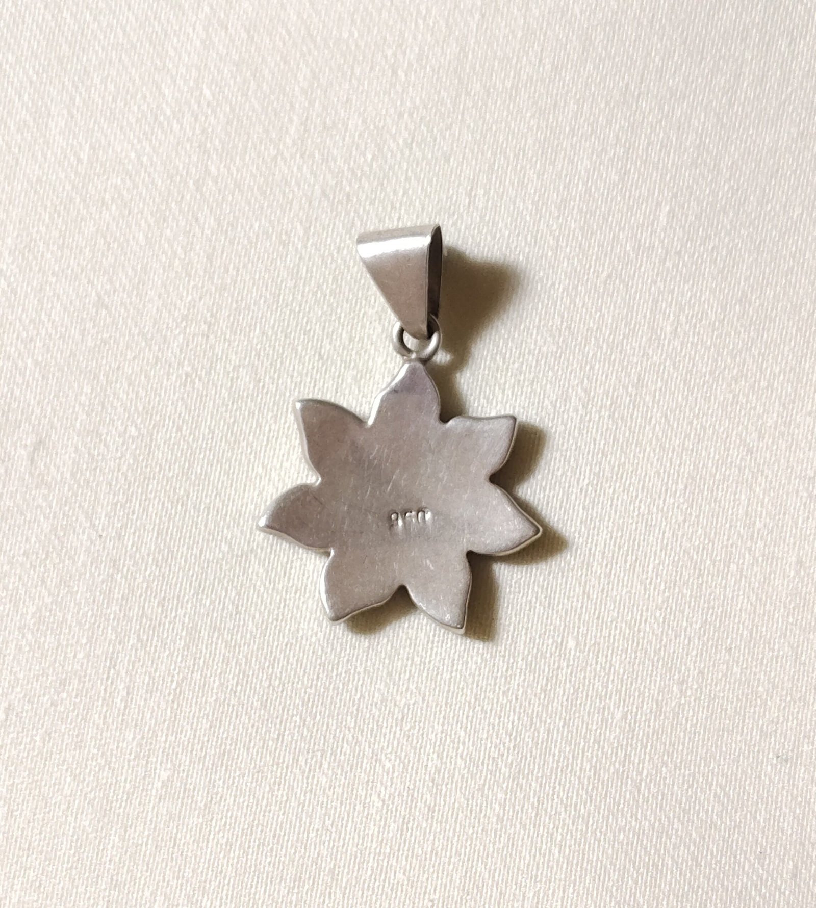 Backside of sun pendant showing its high quality