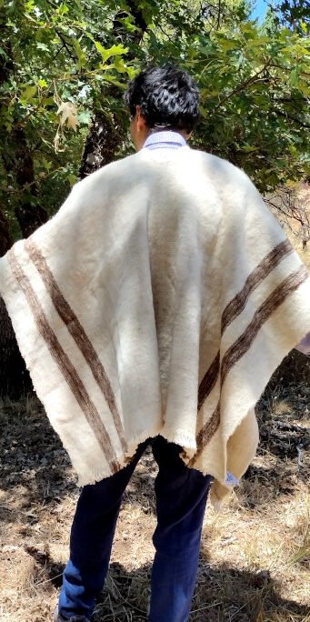Man wearing a hand woven poncho