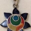 Silver sun pendant with shell and gemstone inlay with all the colors of the rainbow.